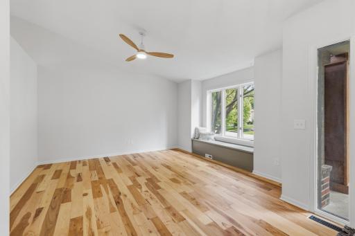 Off the foyer - the Living Room features vaulted ceilings, hickory hardwood floors and a built-in window bench