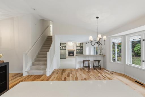 Open layout ~ Dining Room features a built-in snack ledge wrapped in shiplap and a rustic wood top