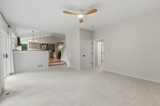 Ceiling fan & door leads to the 1/2 bathroom, office & mudroom / laundry