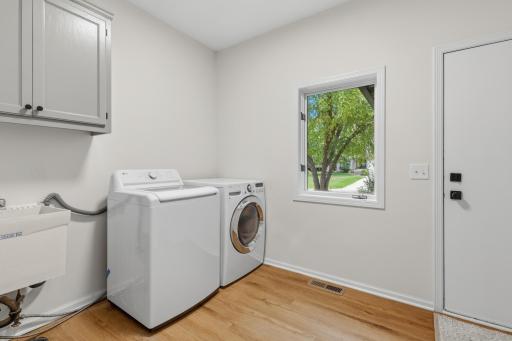 Mudroom & Laundry Room features new luxury vinyl plank flooring and access to the garage