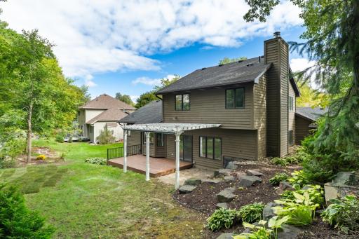 The property features mature shrubs, trees and perennial gardens ~ stunning stone retaining walls!