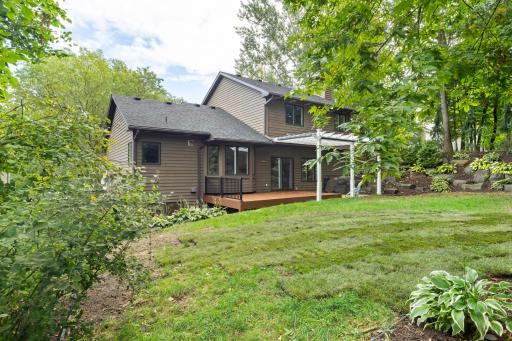 The home has cedar lap and shake siding with brick accents