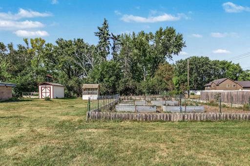 Established garden area with raised planting beds, open space, and room for seasonal vegetables and flowers.