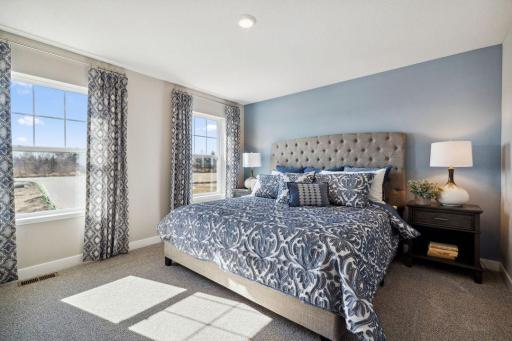 Primary bedroom is a true oasis from the rest of the home. Big windows provide ample natural light. *Picture is of model home; actual finishes may vary.