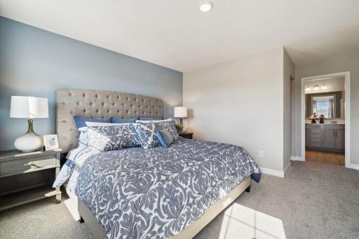 Primary bedroom is a true oasis from the rest of the home. Big windows provide ample natural light. *Picture is of model home; actual finishes may vary.