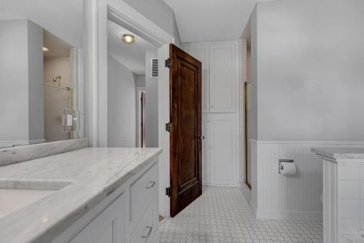Here is a view of the walk in shower and additional storage space.