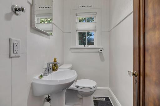 Conveniently located off the kitchen, this charming half bath adds style and functionality to the main living space.