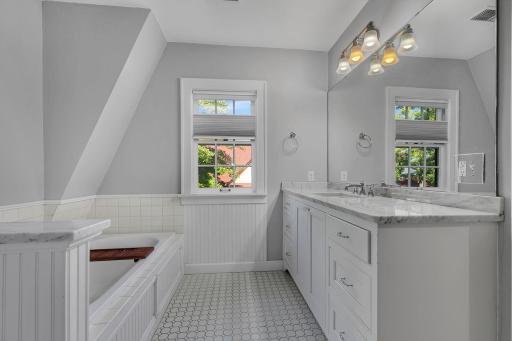 Updated full bathroom featuring a large soaking tub and separate walk-in shower, offering a comfortable and refreshed space.