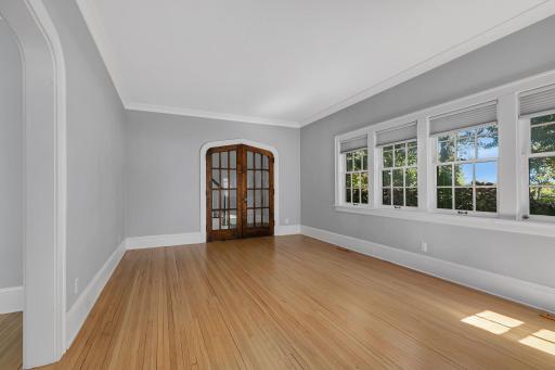 Beautiful arched-top doors with glass panes add character and timeless appeal to the living room.