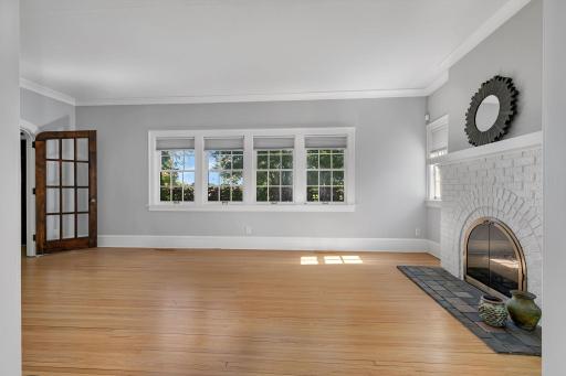 Bright and inviting living room featuring beautiful hardwood floors and fresh, light finishes.