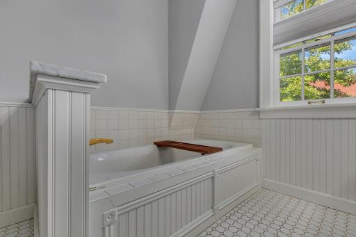 A standout feature of the updated bathroom, the spacious soaking tub offers a relaxing retreat and adds extra appeal to this inviting space.