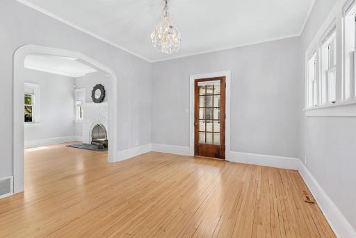 Inviting formal dining room featuring a large archway opening to the living room, creating a seamless connection between the spaces.
