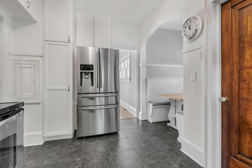 Bright, inviting kitchen featuring crisp white cabinetry, stainless steel appliances, and a clean, timeless design.