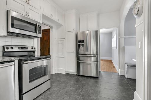 The kitchen is ideally situated next to the formal dining room, creating a desirable layout for easy entertaining and everyday living.