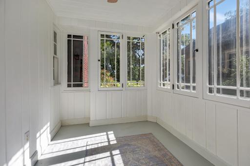A bright and inviting sunroom just off the dining room, offering a relaxing space filled with natural light and the perfect spot to unwind.