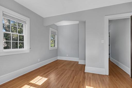 This bedroom features a unique layout with additional space that offers flexibility for a desk area, reading nook, or other personalized use.
