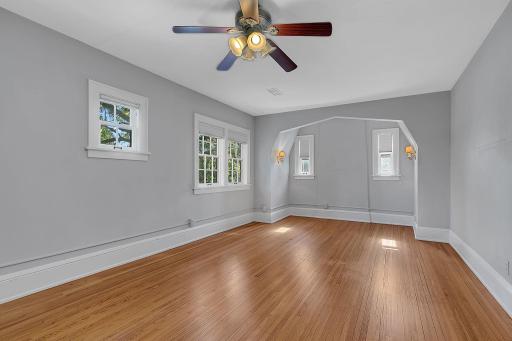 Another view of the upper level bedroom with charming nook and ceiling fan.