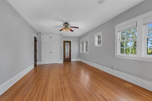 Another view of the bedroom, showcasing the spacious layout and convenient closet area.