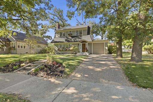 Charming Tudor-style home with timeless character, beautiful mature landscaping, and a welcoming curb appeal. A truly distinctive home with classic architectural details.