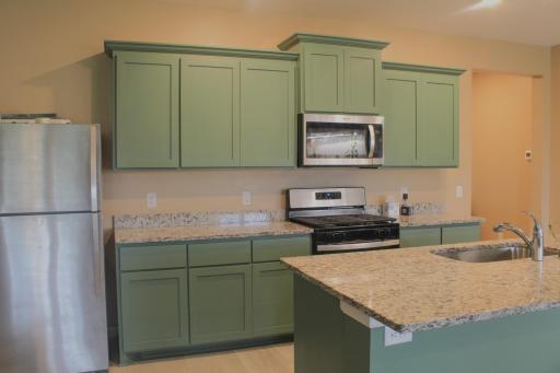 Stainless steel appliances include a fridge, stove, and mircrowave!