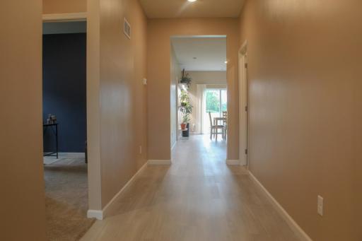 Stepping through the front door, you're greeted with two bedrooms on the left, a bathroom, and laundry room.