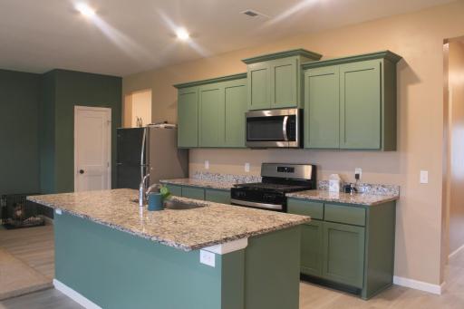 The kitchen offers granite countertops with a center island provides a sink, outlets, and dishwasher!