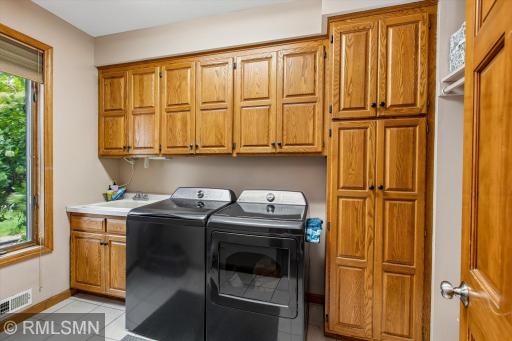 Main floor laundry - with sink and great cabinet space!