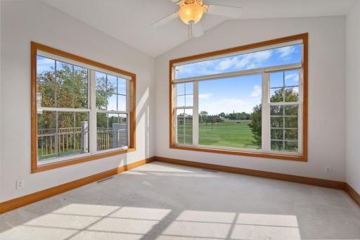 Sun room with windows on 3 sides and ceiling fan