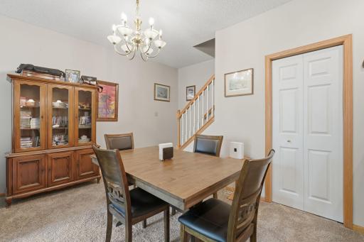 Dining tucked into living room with storage under the stairs