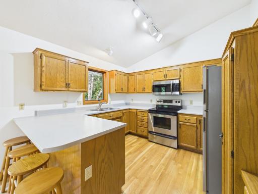 A welcoming Chaska kitchen with stainless steel appliances, generous cabinet storage, and a large peninsula