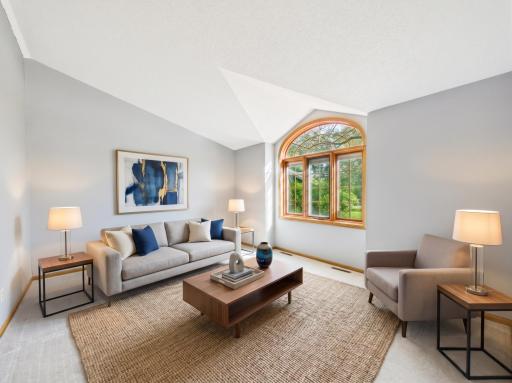 Vaulted ceilings give the living room an airy feel and make the main gathering space stand out. Virtually staged.