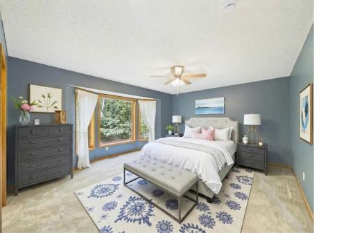 Check out this oversized primary bedroom with bay windows, walk-in closet, new carpet and fresh paint. Explore a possible furniture arrangement. Virtually staged.