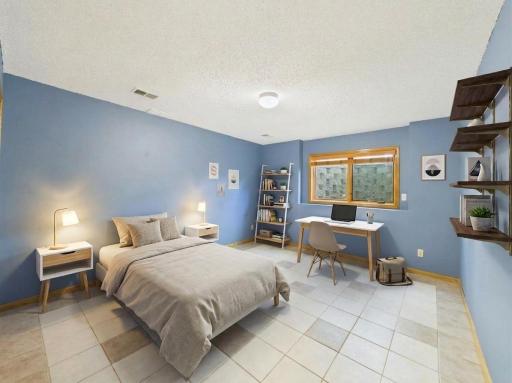 The finished lower-level fifth bedroom pairs with a nearby three-quarter bath for added layout flexibility. Virtually staged.