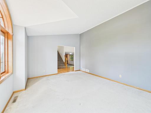 A second perspective on the vaulted living room and its welcoming main-level setting.