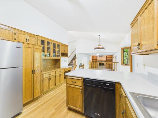 Gather around the large peninsula in a Chaska kitchen with stainless steel appliances and generous cabinet space.