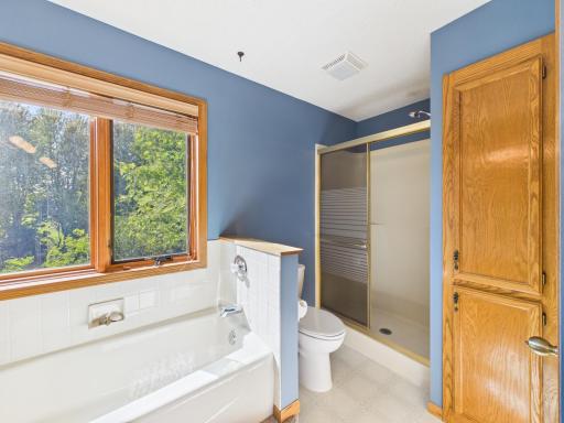 The pass-through full bath features dual sinks, a separate tub and shower, and storage.