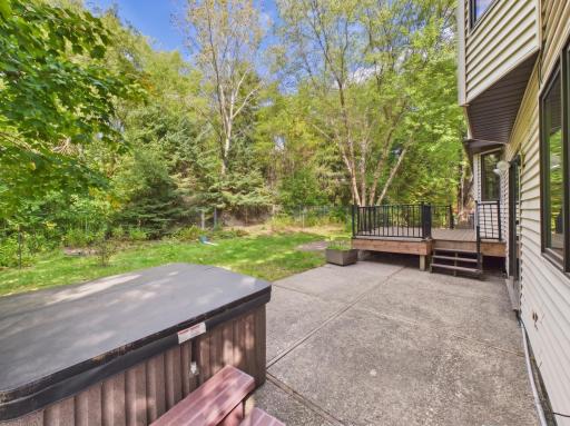 Composite decking and a patio create two inviting ways to enjoy the fenced backyard.