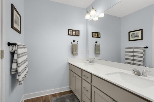 The spacious second-floor main bath offers both style and functionality, featuring a dual-sink vanity, a new comfort-height toilet, and a thoughtfully designed layout with a separate area for the toilet and tub.
