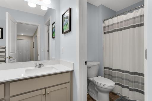 The spacious second-floor main bath offers both style and functionality, featuring a dual-sink vanity, a new comfort-height toilet, and a thoughtfully designed layout with a separate area for the toilet and tub.