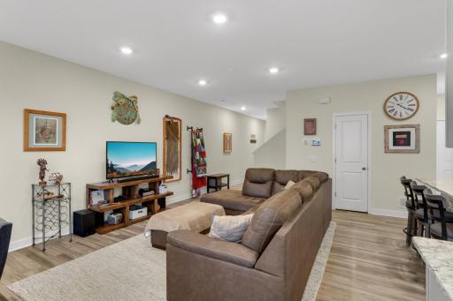 Spacious open-concept main floor featuring inviting living, dining & kitchen areas with luxury LVP flooring, granite countertops, stainless-steel appliances, and a gas range—perfect for everyday living and entertaining.