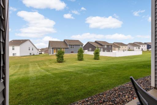 Enjoy a beautiful view of the spacious backyard from the covered patio. With plenty of room to run, play, entertain, or simply relax, this inviting outdoor space is perfect for enjoying the fresh air and making the most of the backyard.