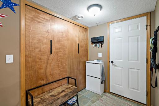 Mudroom with adjacent laundry room off of the garage
