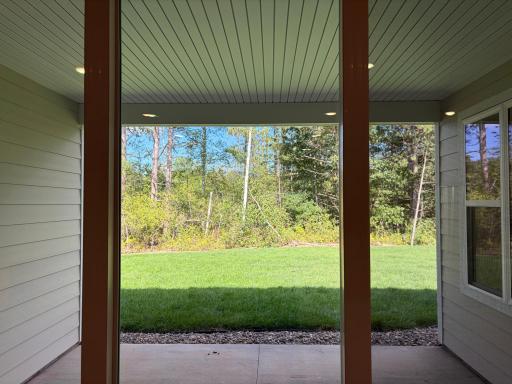 Featuring amazing scenery, a covered porch allows you to relax in comfort. Model photo (Home under construction)