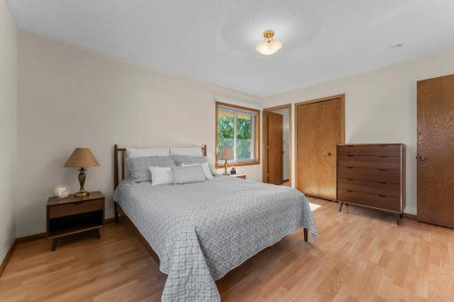 Spacious primary bedroom features two closets for excellent storage.