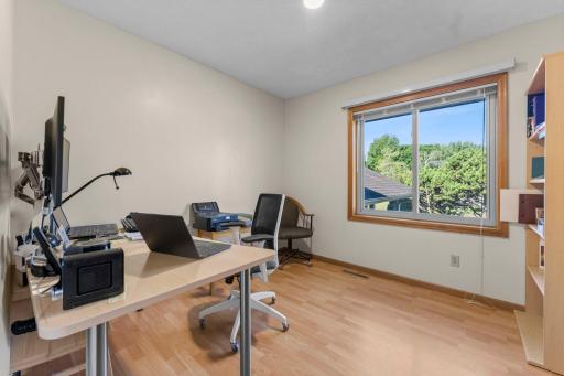 Third upper-level bedroom offers another bright and versatile living spac