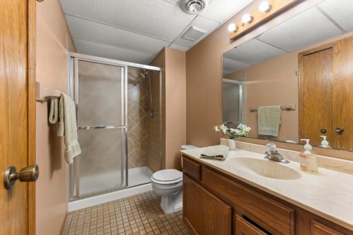 Lower Level bath with tile floor, tiled shower and large linen closet.