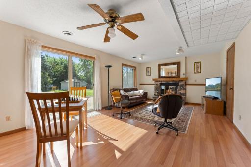 Beautiful brick-front wood-burning fireplace anchors the lower-level family room.