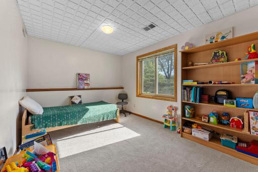 Lower level features three additional bedrooms with plush carpeting installed in 2021. 5th Bedroom with newer carpeting, overhead lighting, generous closet and large window.