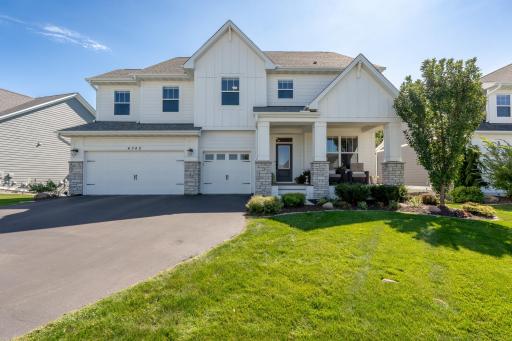 Welcome home! Beautiful curb appeal with a three-car garage, welcoming covered front porch and manicured landscaping