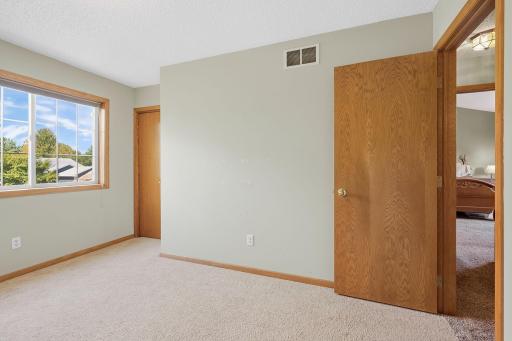 Fourth bedroom on the upper level, currently used as a gym space with great natural lighting.